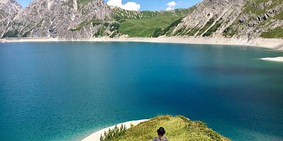 bild von einem bergsee an dem nora sonnenberg sitzt.